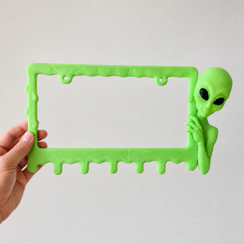 Slime Green alien frame held in a hand to show its size
