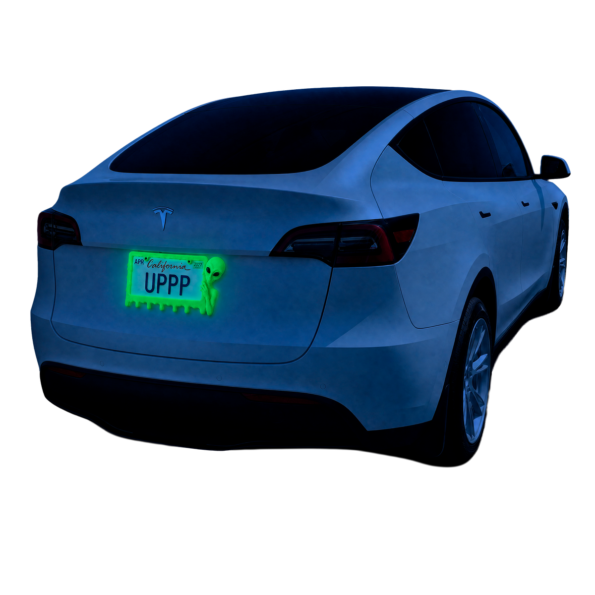 White Tesla with a UPPP alien license plate frame starting to glow green at blue hour
