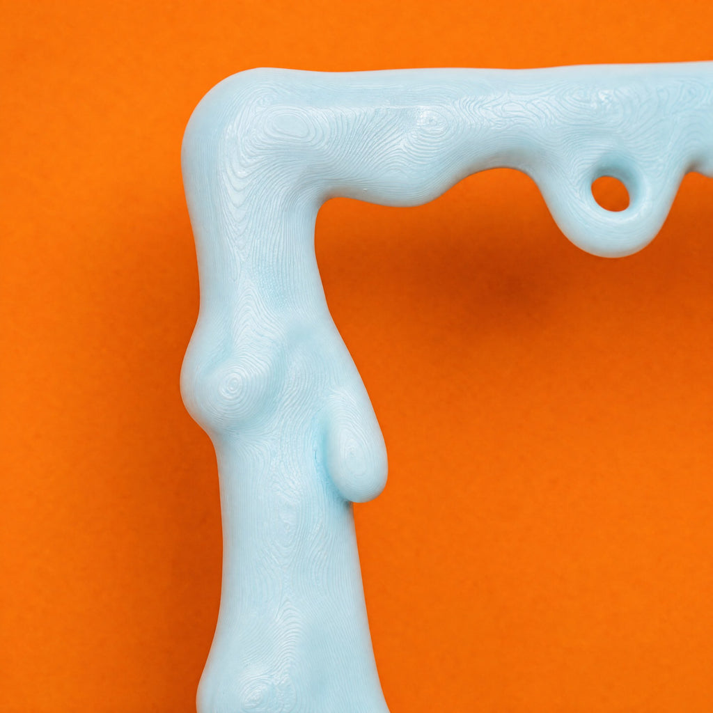 Close-up of a pale blue slime drip running down the corner of the frame