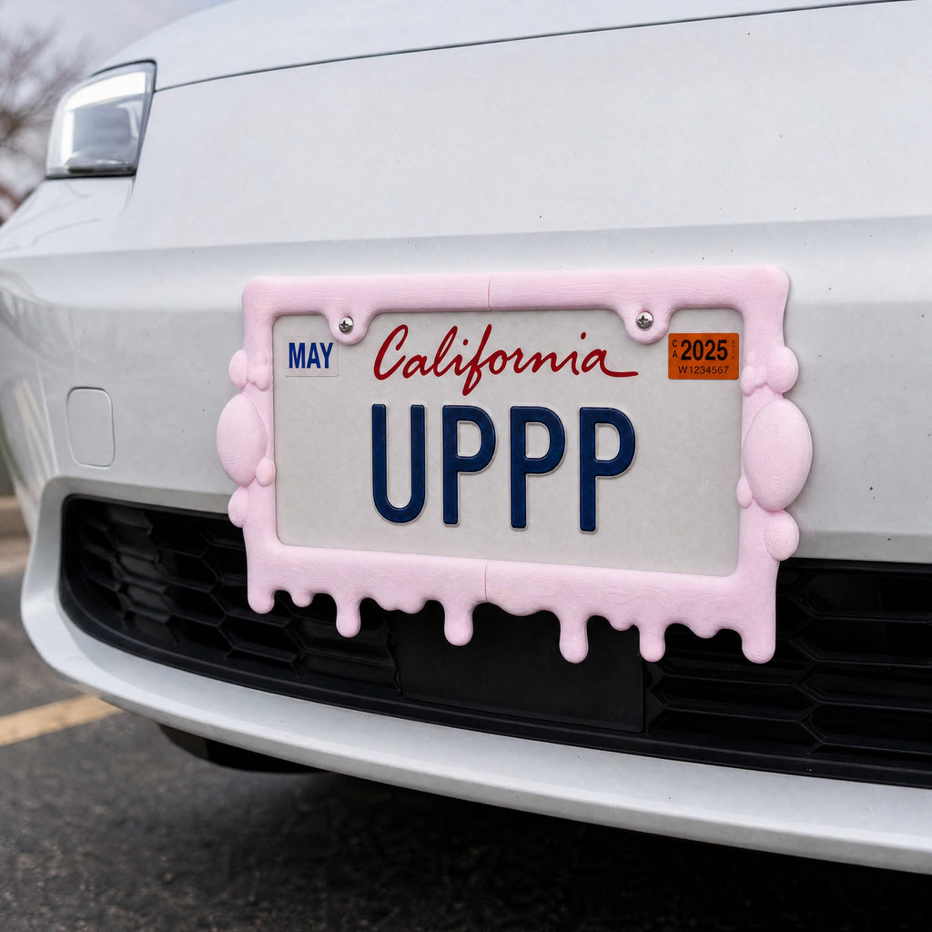 Pink slime license plate frame mounted on the front bumper of a white car