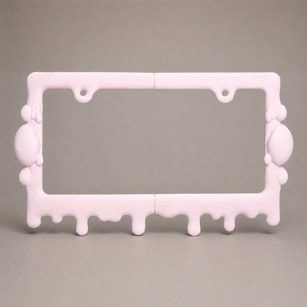 Bubblegum pink drip license plate frame on a neutral grey backdrop