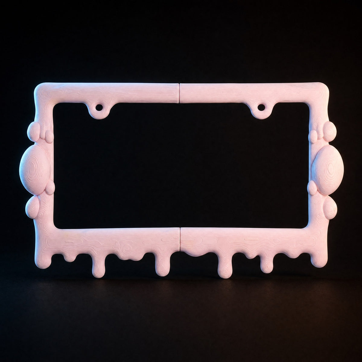 Pink slime license plate frame lit from the sides against a black background