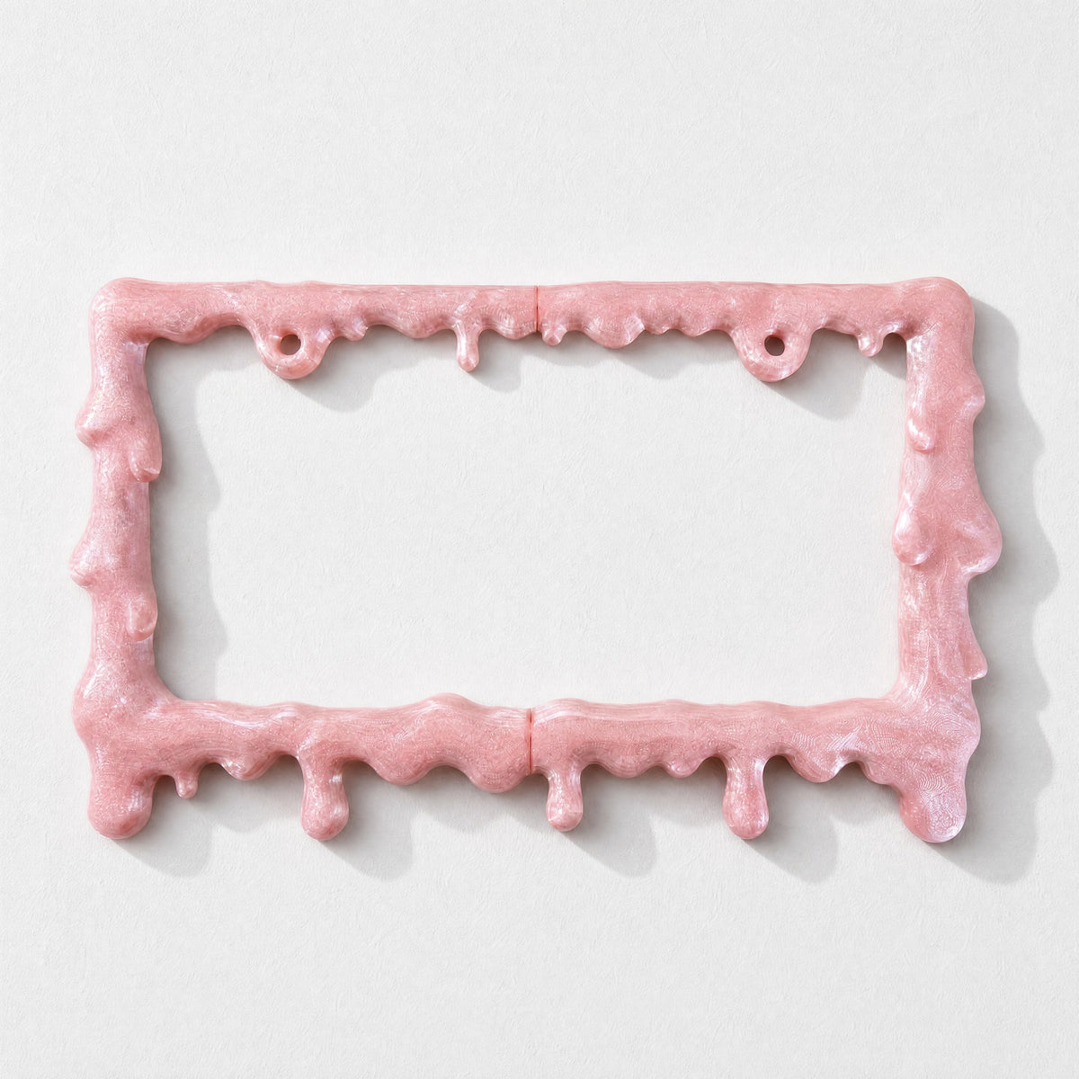 Empty crystal pink slime license plate frame on a white background