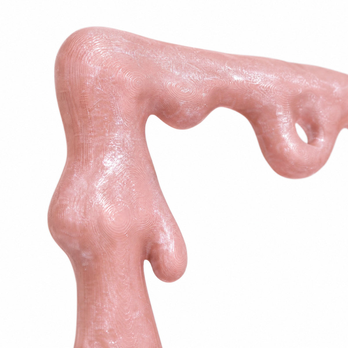 Macro of a glitter-flecked pink drip on the corner of the frame