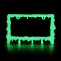 Glow in the dark slime license plate frame glowing green in a dark room