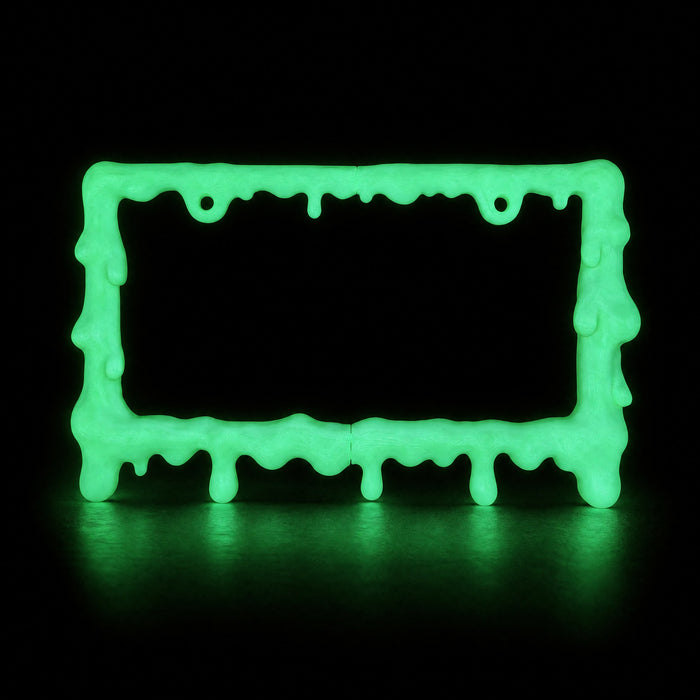 Glow in the dark slime license plate frame glowing green in a dark room