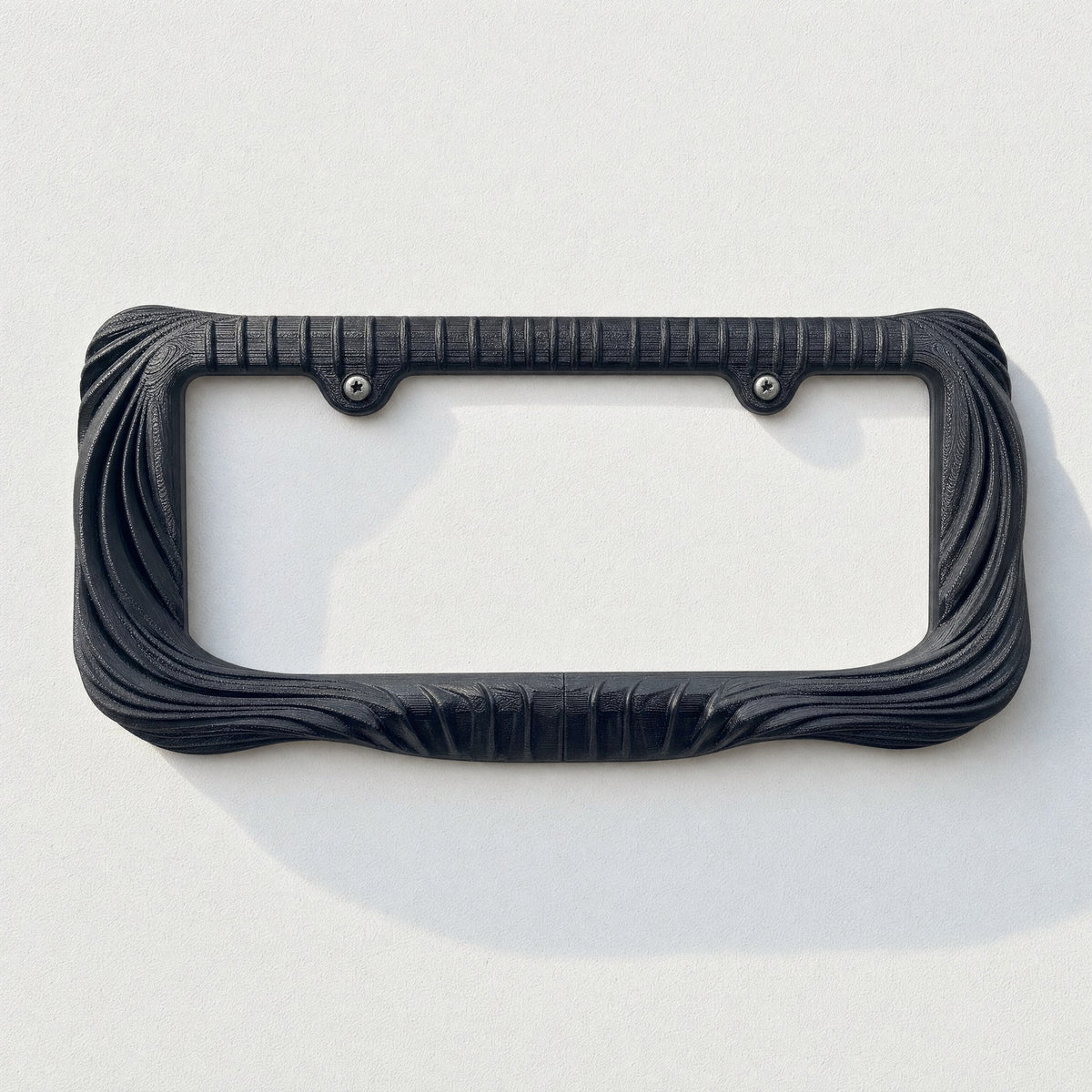 Empty black draped license plate frame on a pale grey background