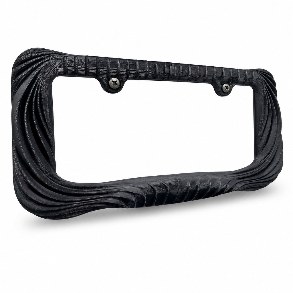 Black Utopia license plate frame at a three-quarter angle above its shadow