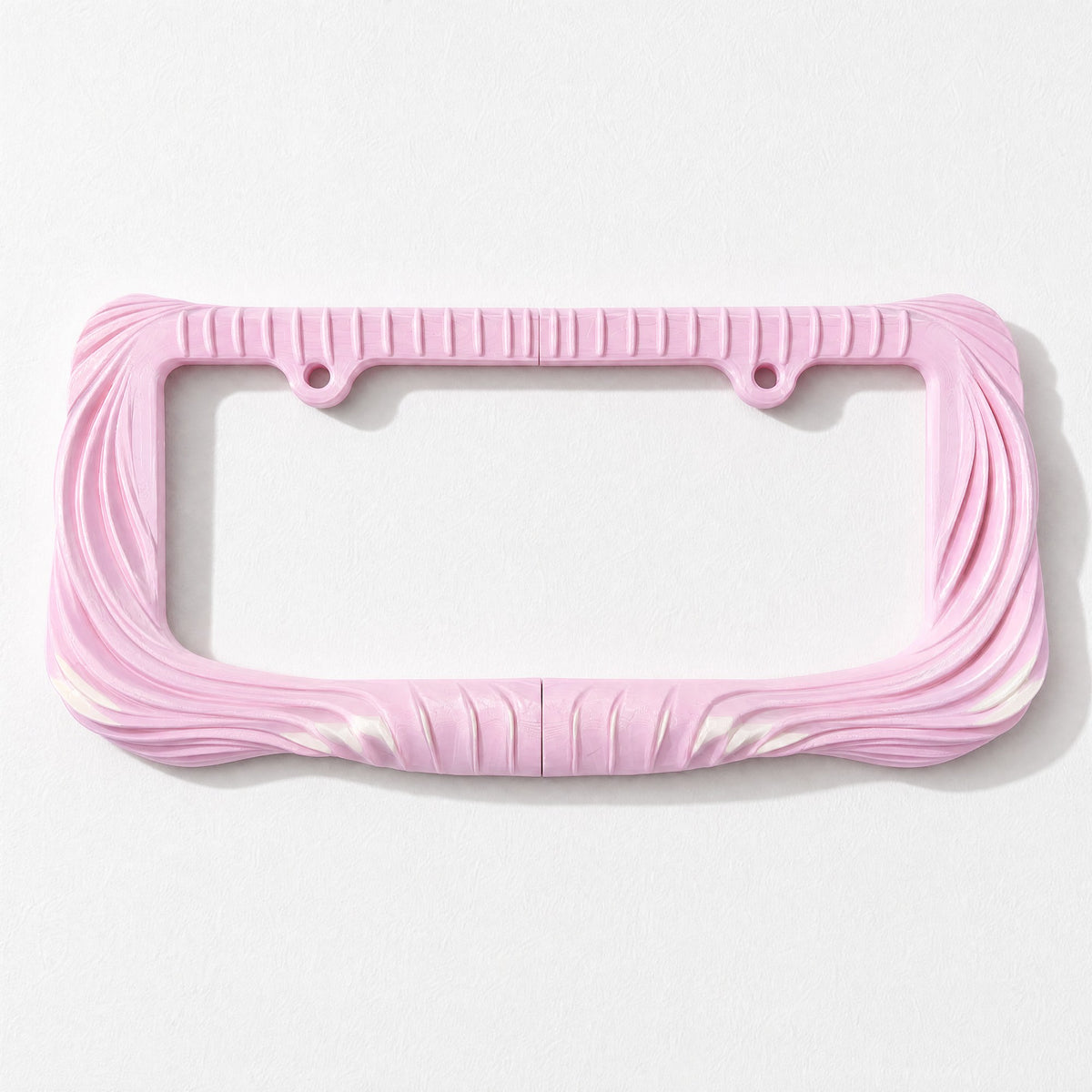 Empty blush pink draped license plate frame on a pale grey background