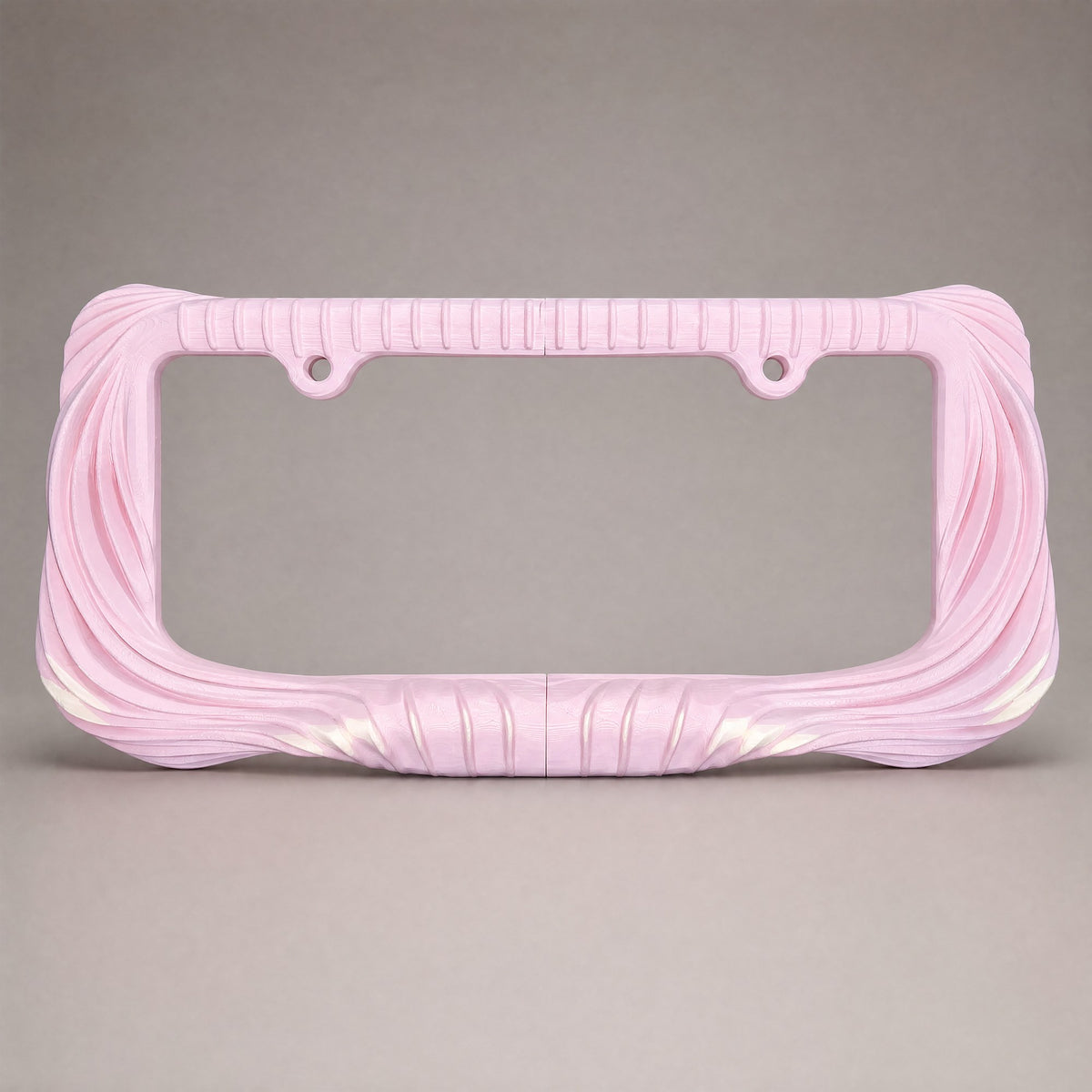 Blush pink draped license plate frame straight on against a grey backdrop