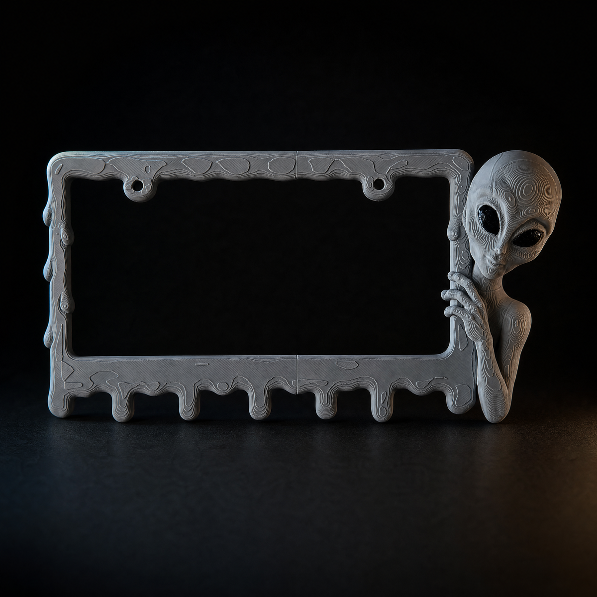 Graphite alien frame on a charcoal background with rim lighting