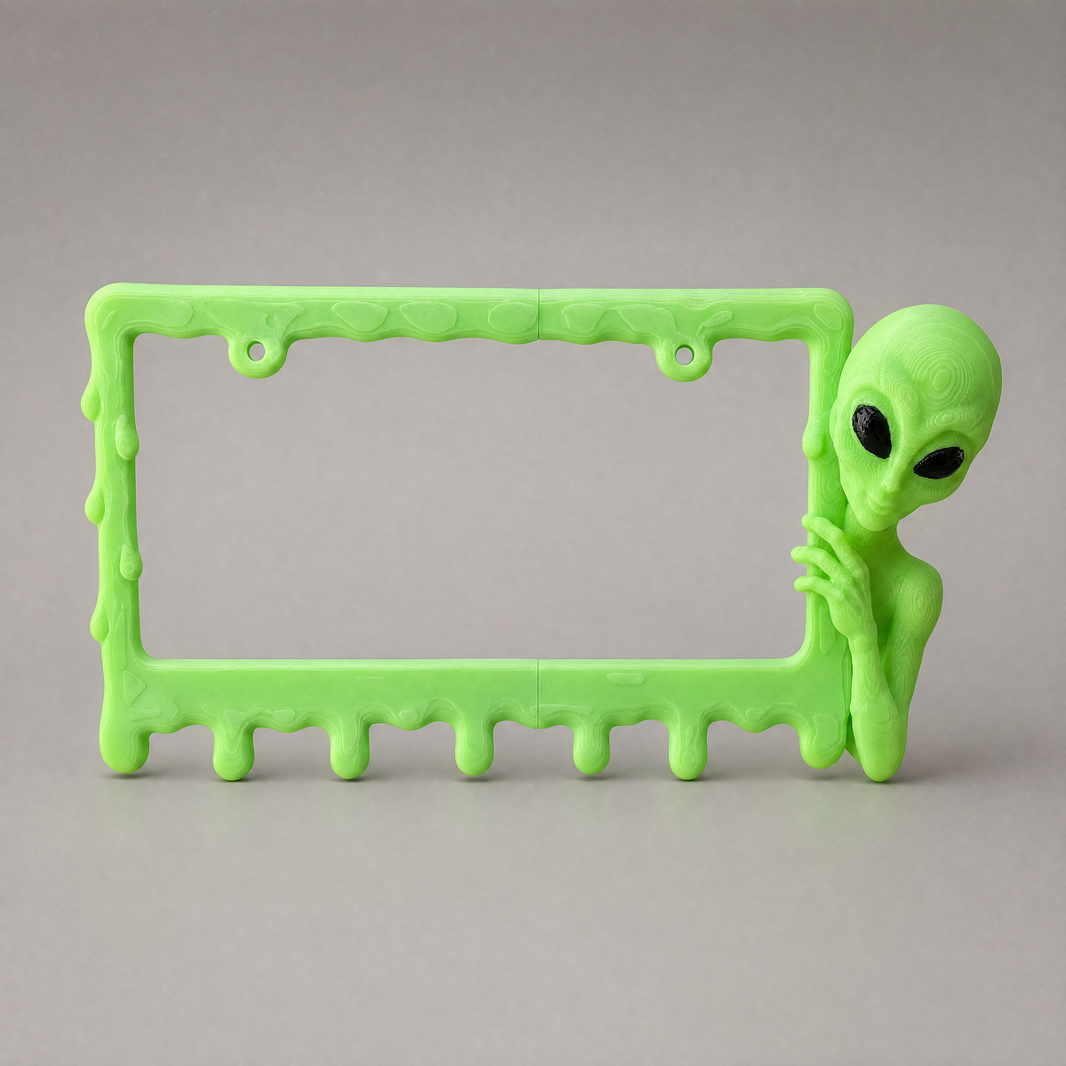 Slime Green alien frame on a neutral grey studio backdrop