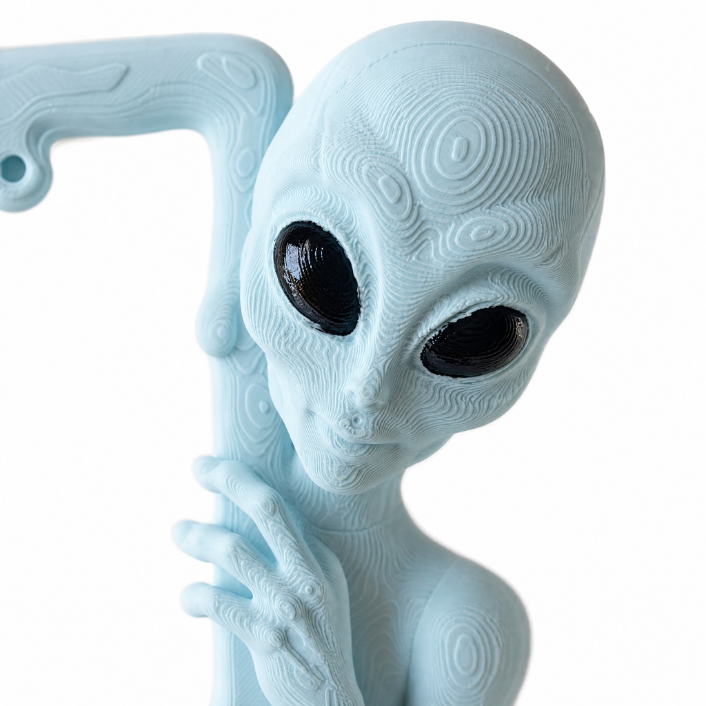 Close-up of the sculpted alien head in Ice Blue with hand-painted black eyes