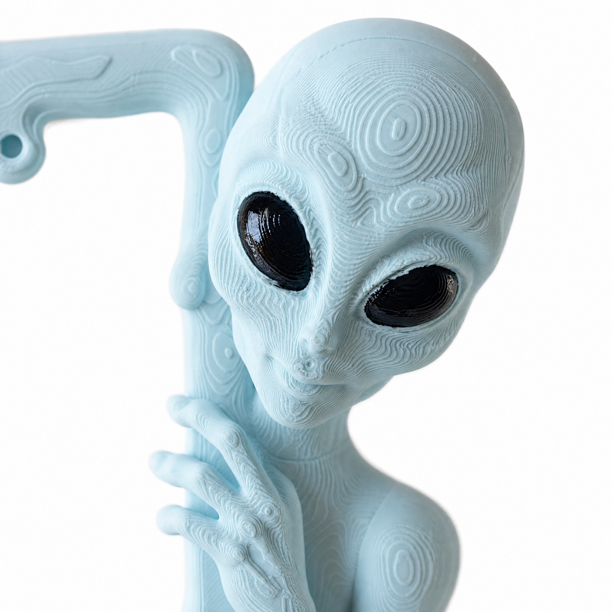 Close-up of the sculpted alien head in Ice Blue with hand-painted black eyes