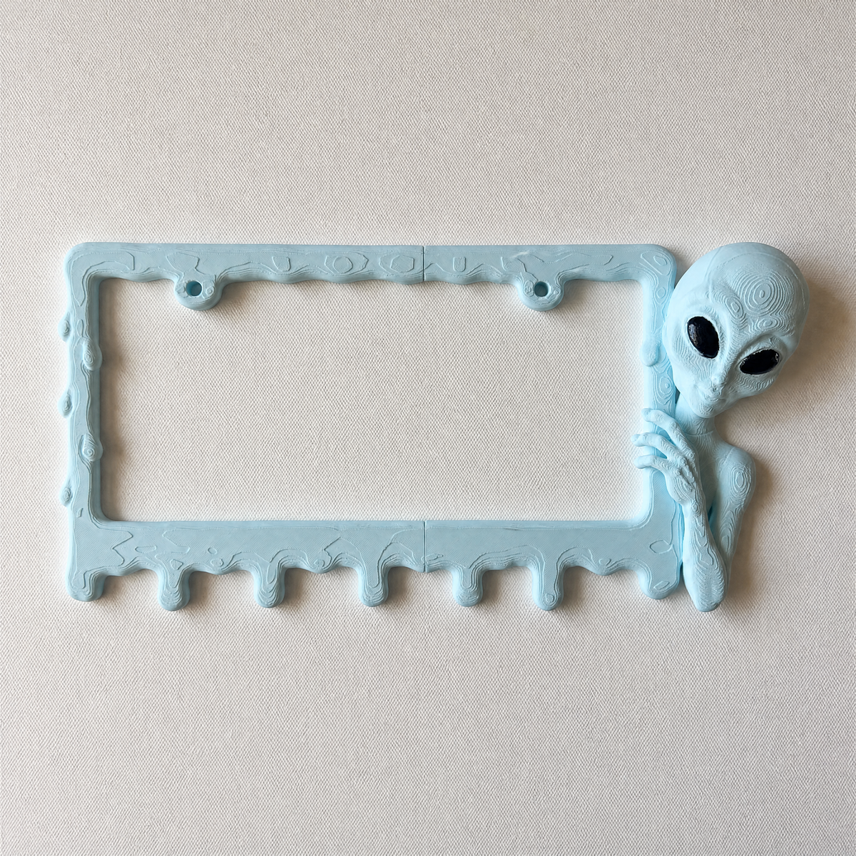 Ice Blue alien frame photographed from above on a clean white surface
