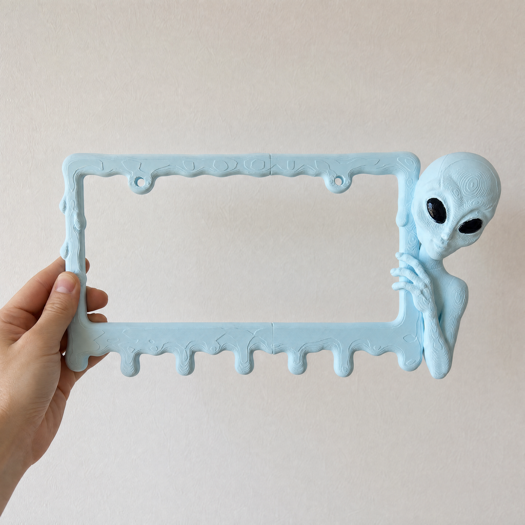 Ice Blue alien frame held in a hand to show its size