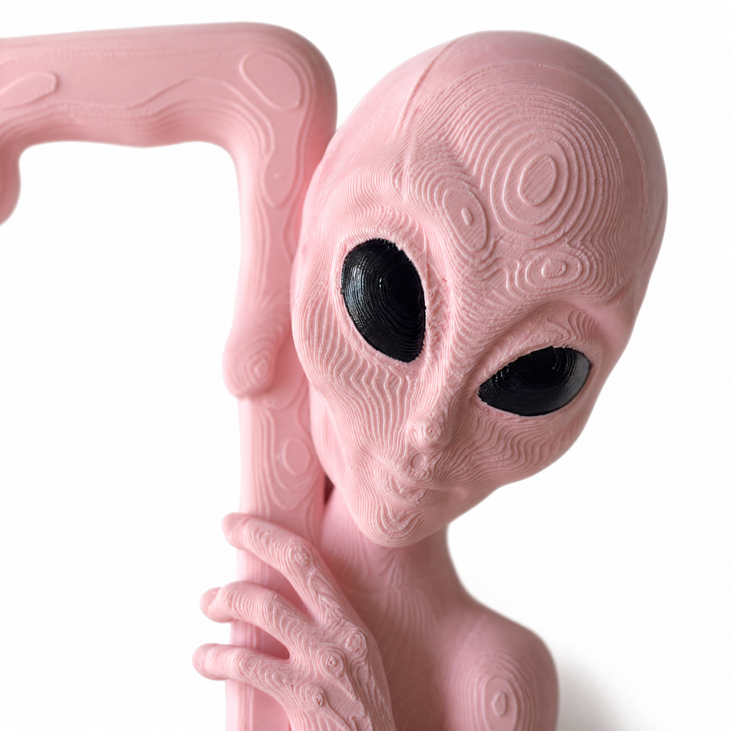 Close-up of the sculpted alien head in Bubblegum pink with hand-painted black eyes