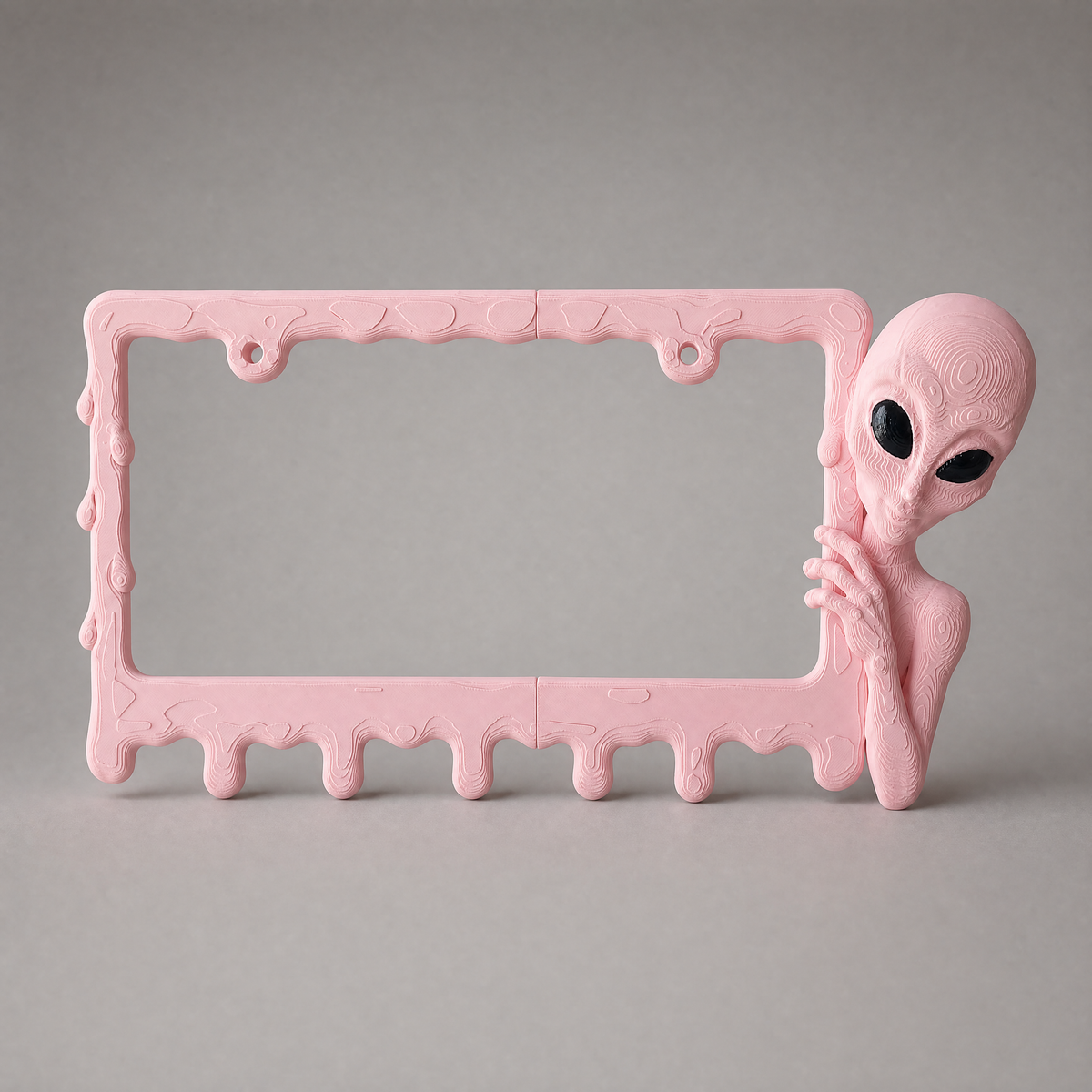 Bubblegum alien frame on a neutral grey studio backdrop
