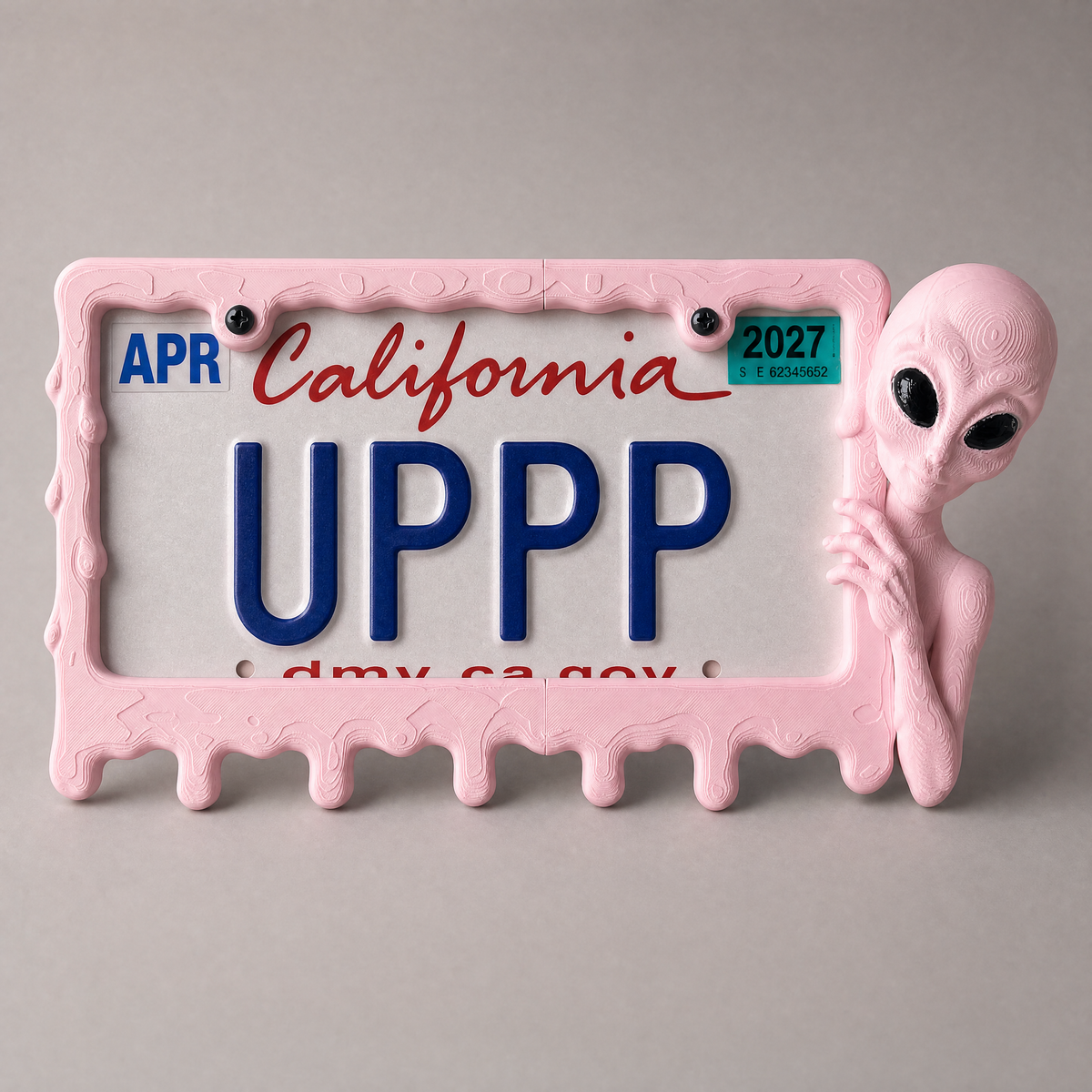 Bubblegum alien frame with a California plate on a grey backdrop